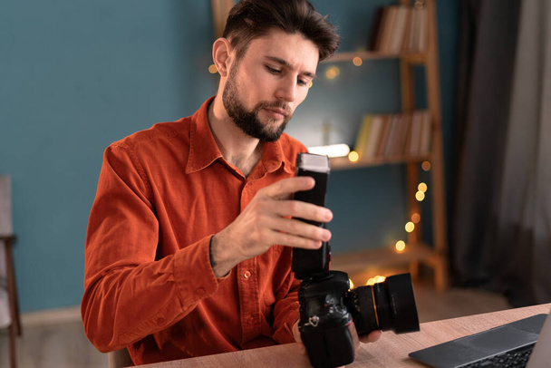 Retrato de um fotógrafo estudante assistindo a um curso on-line para fotógrafos. Equipamento de câmera digital e configurações no escritório em casa. Espaço de cópia - Foto, Imagem