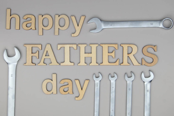 Happy father's day letters on gray background with tools - Φωτογραφία, εικόνα