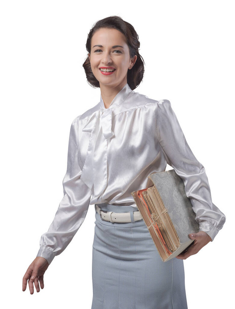 1950s style secretary holding a folder with documents and paperwork - Foto, imagen