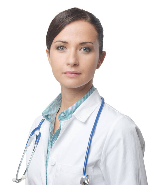 Confident smiling female doctor posing with lab coat and stethoscope. - Фото, зображення