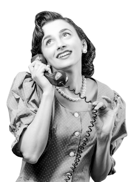 Vintage style woman holding the receiver and having a phone call, she is having a romantic call - Foto, Imagem