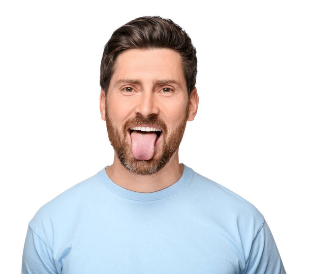 Man showing his tongue on white background - 写真・画像