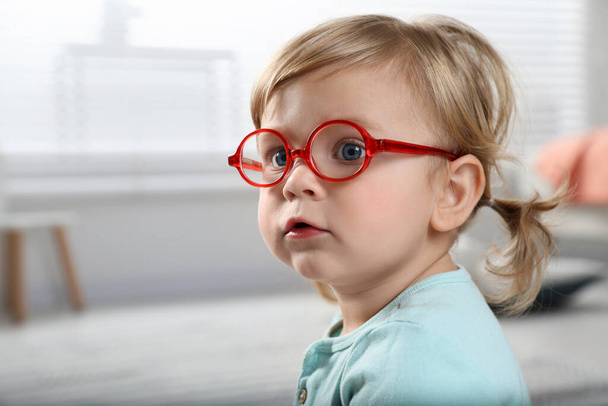 Cute little girl in glasses at home. Space for text - Foto, imagen