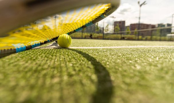 Ρακέτα του τένις με μια μπάλα του τένις σε γήπεδο τένις. - Φωτογραφία, εικόνα