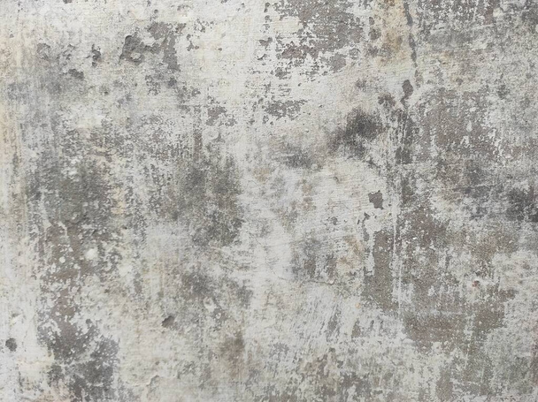Crushed Dirty cracked white wall paint peeling off.Badly damaged old wall with peeling paint.Patches of paint are missing.cement scratched peeled off weathered grunge wall texture.creaking wall.Peeling Grunge Wall Texture.Patched and Deteriorating. - Photo, Image