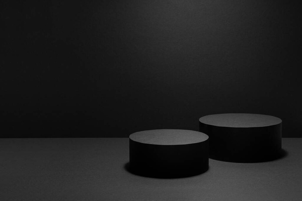 Abstract black stage with two round podiums in light beam with light spot mockup for presentation cosmetic products, goods, advertising, design, showing with soft gradient in beauty fashion style. - Photo, image