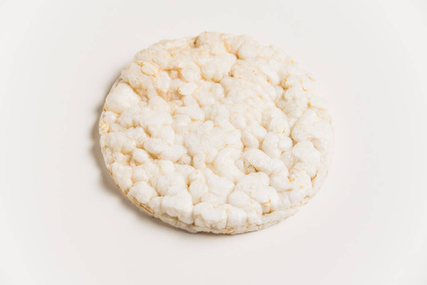 Delicious crispy puffed rice bread on white background with copy space. Diet and healthy eating concept - Foto, immagini