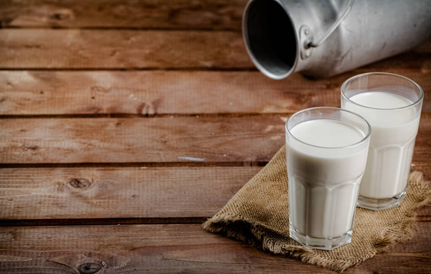 A glass of homemade village milk. On a wooden background. High quality photo - Fotó, kép