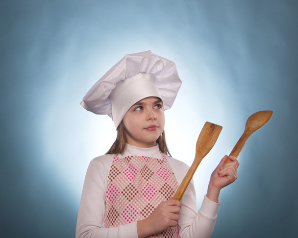 The girl with chef hat indicates isolated - Фото, изображение