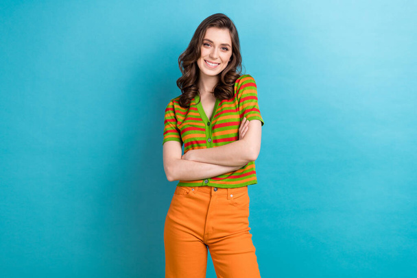 Photo of young lady folded arms satisfied smile good mood wear striped trendy t-shirt non formal clothes isolated on blue color background. - Fotografie, Obrázek