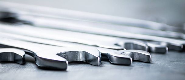 Metal wrench on the table. On a gray background. High quality photo - Foto, immagini