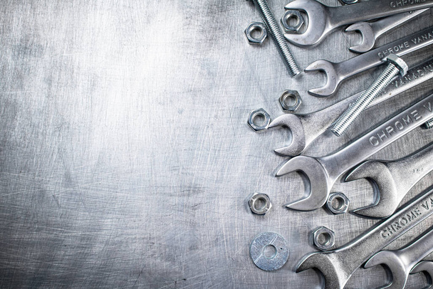 Wrench with nuts and bolts. On a gray background. High quality photo - Foto, immagini