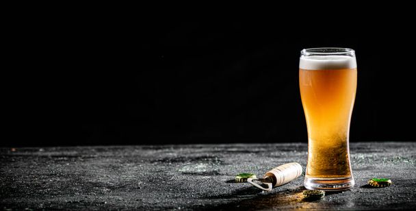 Glass with beer . On rustic background. - Foto, Imagen