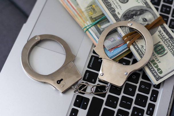The handcuffs are on hundred-dollar bills. Power and bribery. Criminal ransom. Criminal earnings. Business concept. The concept of wealth. High quality photo - Photo, Image