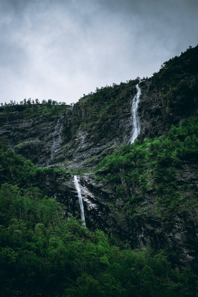 Moody landscape with a waterfall falling on the Naeroyfjord in Gudvangen, Norway - Photo, Image