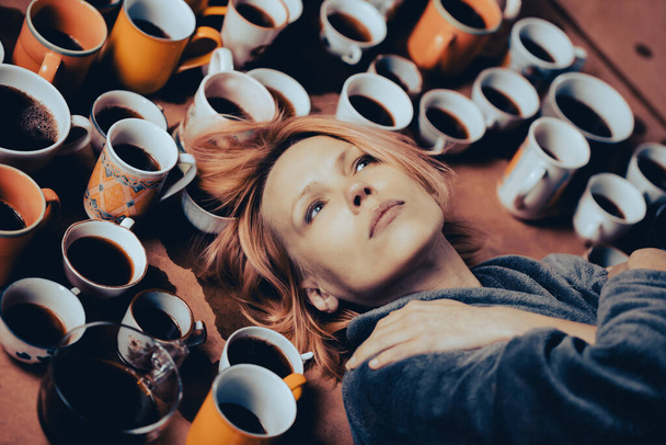 Sleepless, awake woman surrounded by many cups of coffee. Deadline, keep up, be in good shape, overtime concept. - Foto, Imagem
