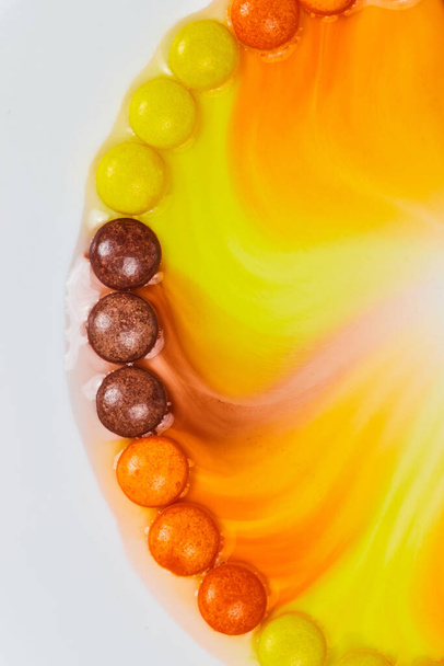Image of Halloween candy in water seeps to off center middle on white background - Photo, Image