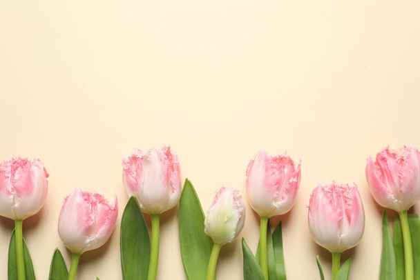 Beautiful colorful tulip flowers on beige background, top view. Space for text - Φωτογραφία, εικόνα