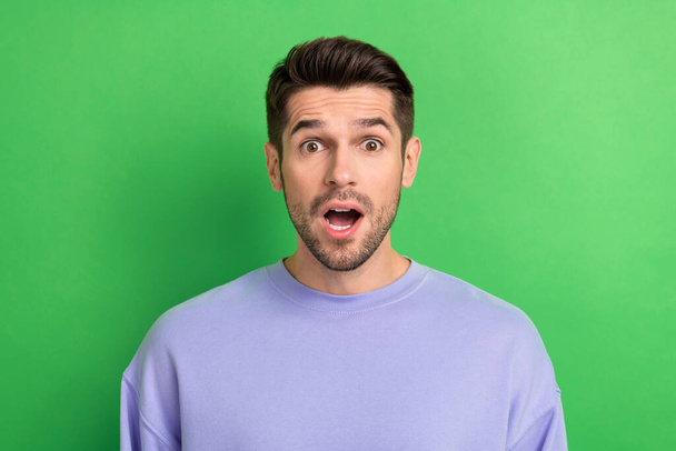 Photo of impressed excited young man wear purple outfit big eyes open mouth isolated green color background. - Valokuva, kuva