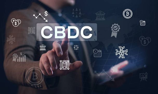 The concept of the digital currency of the Central Bank CBDC. The businessman clicks on a digital hologram with a CBDC concept presentation. Digital currency. Blockchain - 写真・画像