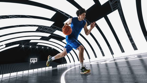 Young man in blue uniform, basketball player in motion, dribbling ball at 3D basketball arena, court with lights. Concept of professional sport, competition, action, competition, game - Foto, Imagen