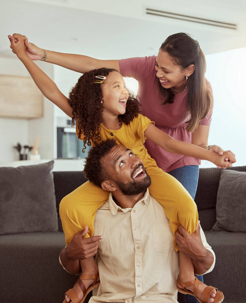 Family home, pretend airplane and kid with mom, dad and young girl together with fun. Living room, mother and father with a child by sofa with love, bonding and parent support with a smile in lounge. - Fotoğraf, Görsel