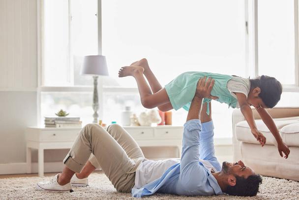Love, airplane and father with girl on a floor for games, fun and playing in their home together. Happy, flying and child with parent in living room for bonding, relax and enjoying weekend in lounge. - Фото, зображення