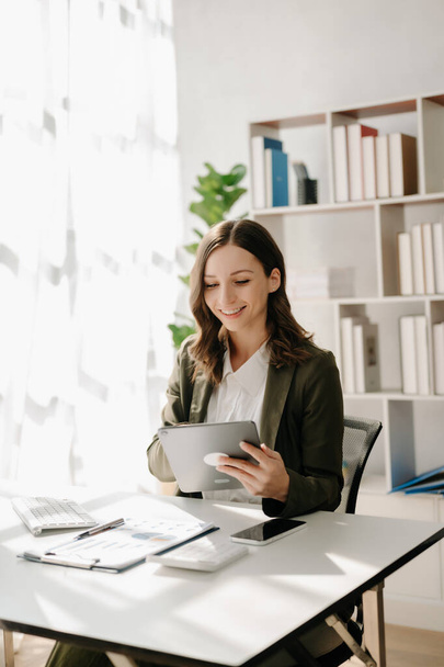 Confident woman  holding  tablet at the modern office - Photo, Image