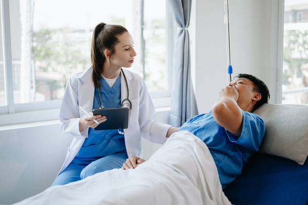  Caucasian doctor  take care of male patient in hospital. Friendly nurse or therapeutic treat client, Professional medical service concept. In the hospital - Photo, image