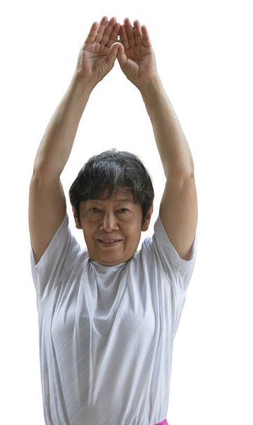 Old lady rasie hands up in the air for stretching body before exercise. - Photo, Image