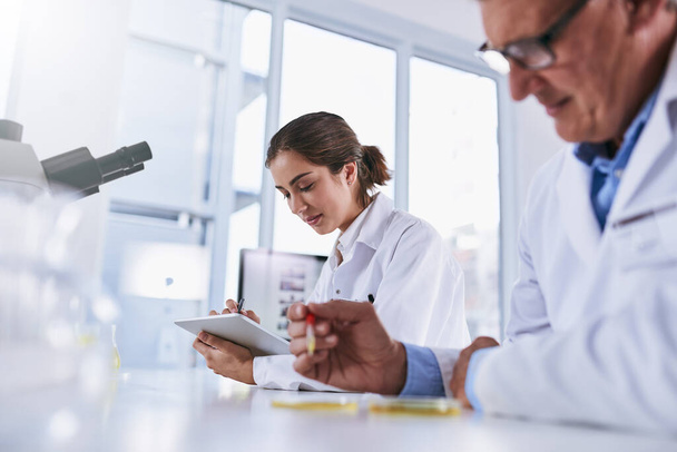 Scientist, tablet and team in science research, experiment or results together at laboratory. Woman and man in medical healthcare working on technology and samples in forensic or scientific lab. - Photo, Image