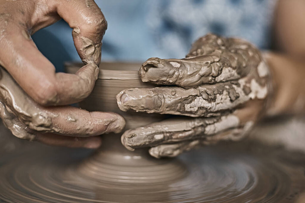 Hands of craftsman artist working on pottery wheel.Selective Focu - 写真・画像