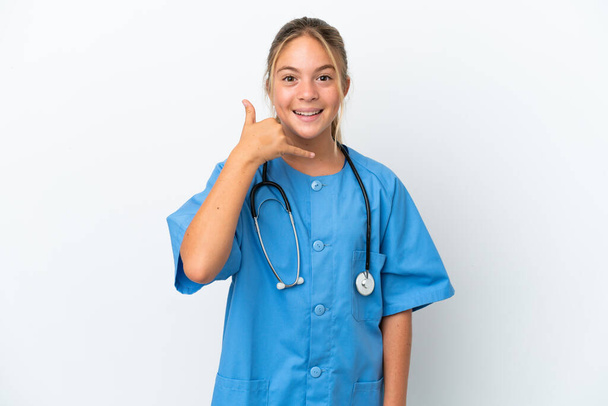 Little caucasian girl disguised as surgeon isolated on white background making phone gesture. Call me back sign - Foto, afbeelding