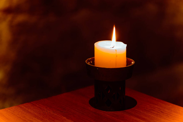 a burning candle in the darkness - Photo, Image