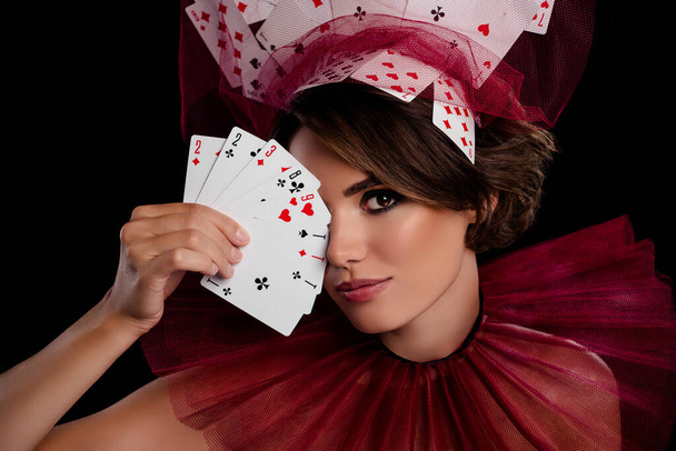 Studio photo stunning woman dealer hold cards near face close eye wear masquerade costume casino night game. - Photo, Image