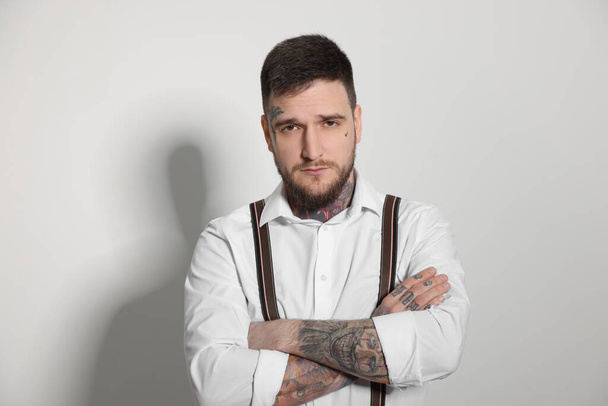 Portrait of handsome hipster man on light grey background - Foto, imagen