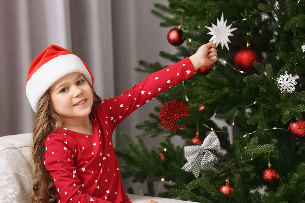 Happy girl near Christmas tree at home - Φωτογραφία, εικόνα