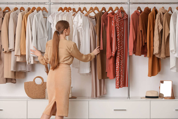 Vendedor femenino con ropa elegante en boutique - Foto, imagen