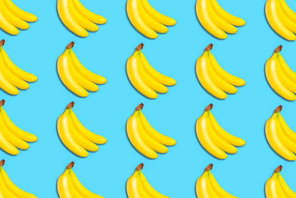Lot ripe bananas. Bananas on blue background. Fruit background. Vegetables, fruits Food - Фото, изображение