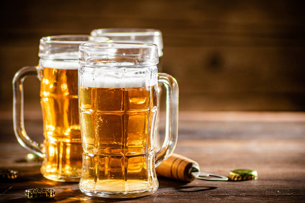 Glasses with fresh beer. On wooden background. - Zdjęcie, obraz
