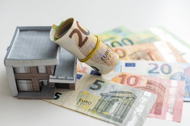 Small Model House on Layer of One Hundred Dollar Bills. High quality photo - Fotografie, Obrázek