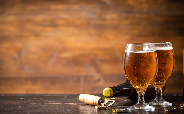 Glasses with fresh beer. On rustic background. - Foto, afbeelding