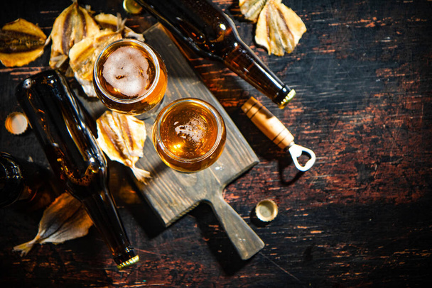 Beer and dried fish. On rustic background. - Foto, imagen