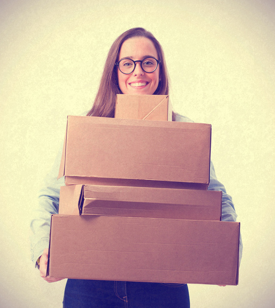 young woman holding cardboard boxes. isolated - Foto, Bild