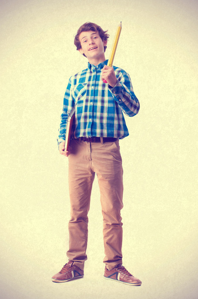 teenager holding a pencil and notebook - Valokuva, kuva