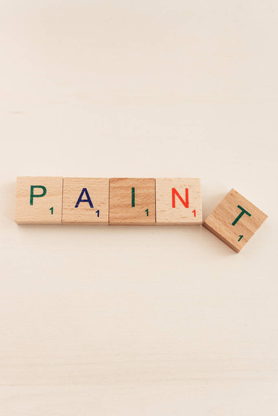 Word pain and paint in wooden cubes. Choice concept. Word paint in letters. Negative or positive. Alphabet in wooden blocks. Creative design. Colourful letters on cubes. - Photo, Image