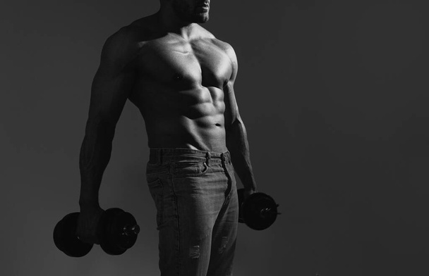 Sexy sporty torso, man with dumbbells. Strong muscular man. Workout lifestyle concept. Handsome man doing functional training workout - Foto, Imagen