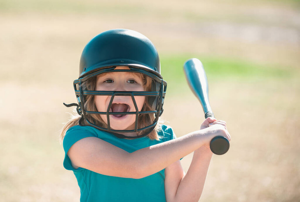 Funny kid up to bat at a baseball game. Close up portrait - 写真・画像