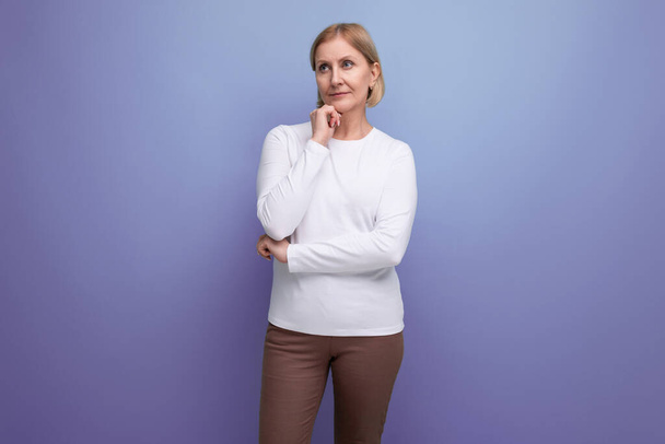 blond pensive middle-aged woman in a white sweater. - Photo, Image