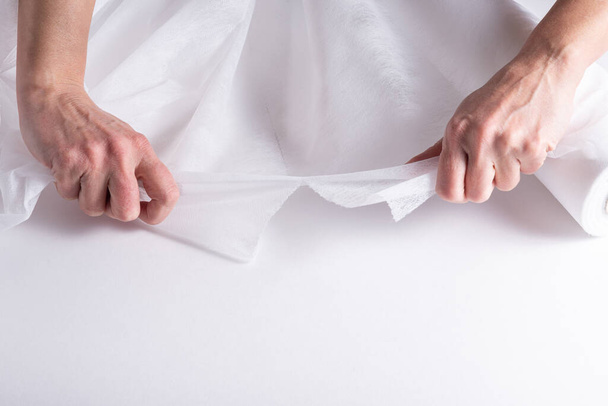 Woman hands working with  Covering Roll for Medical Bed - Photo, image